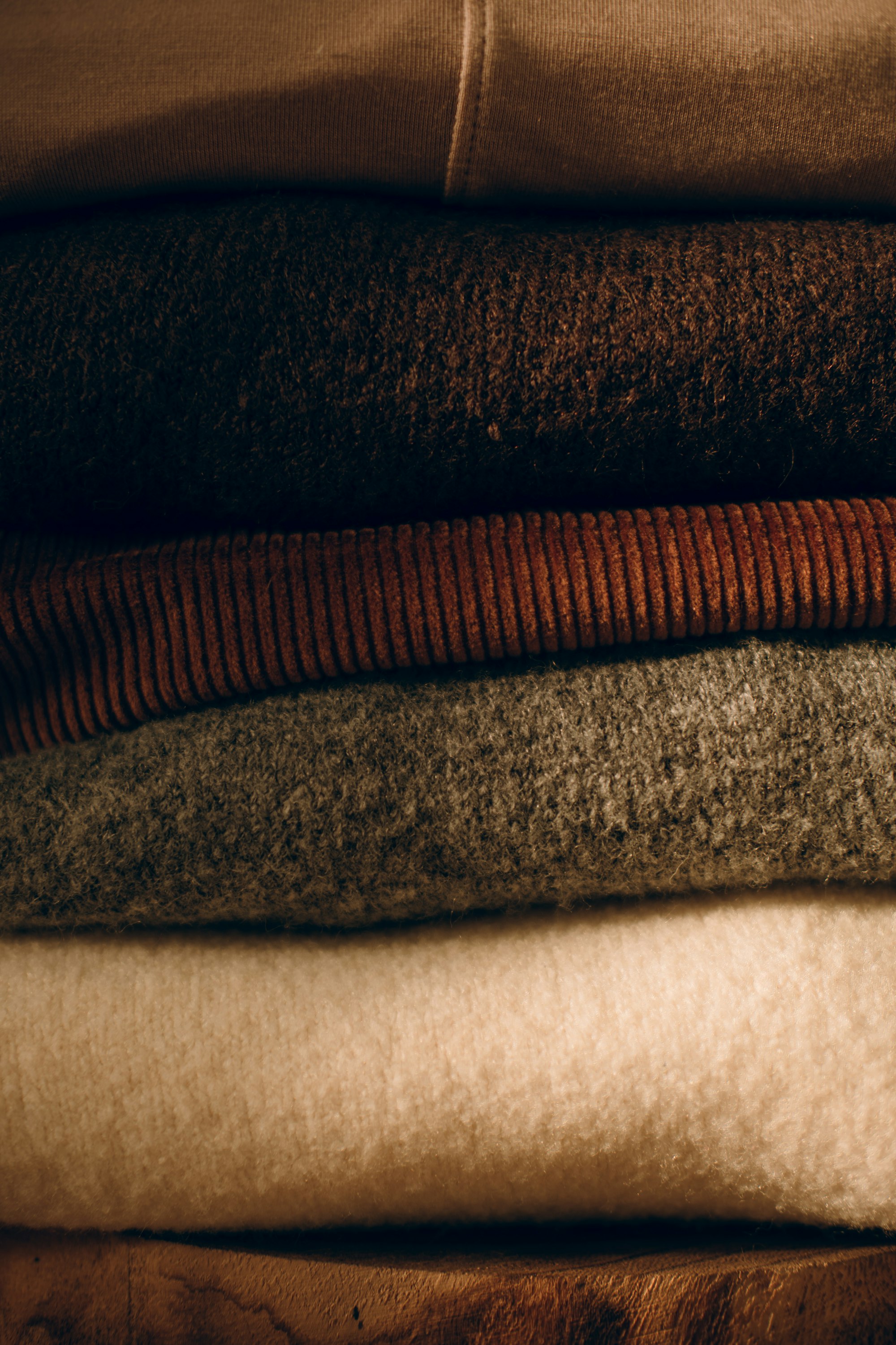 stack of knitwear in earth tones