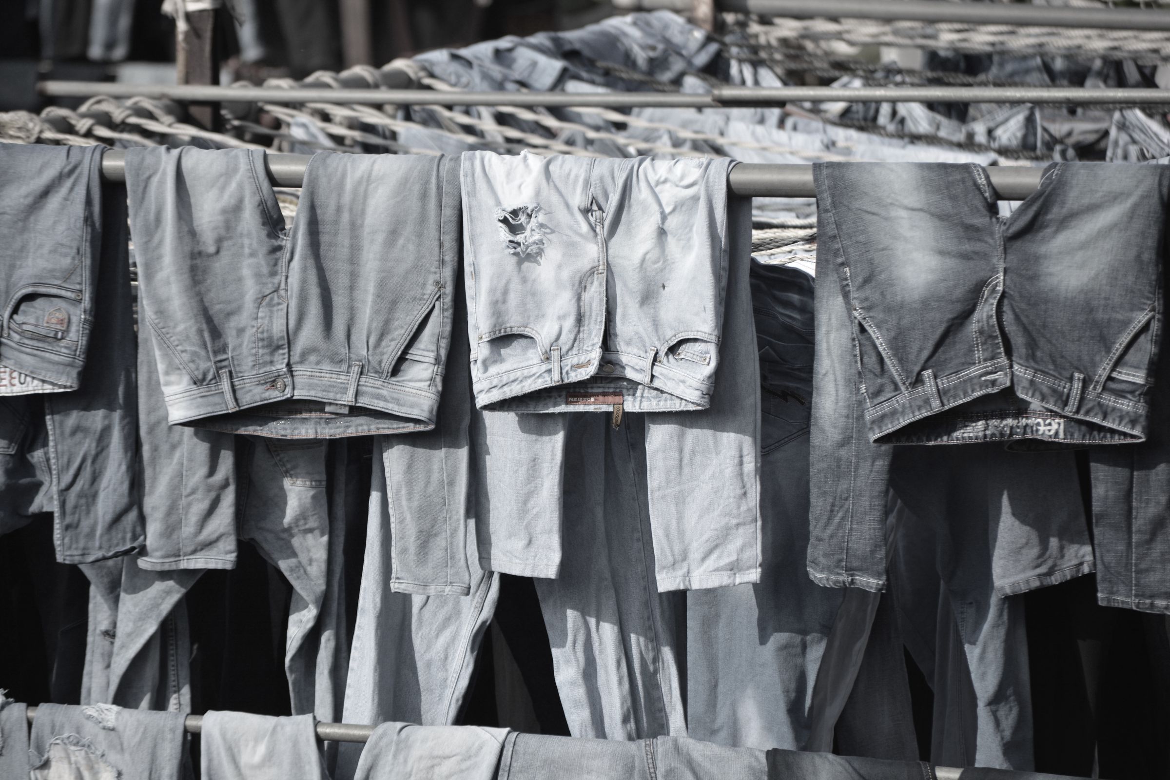 jeans drying on a rail