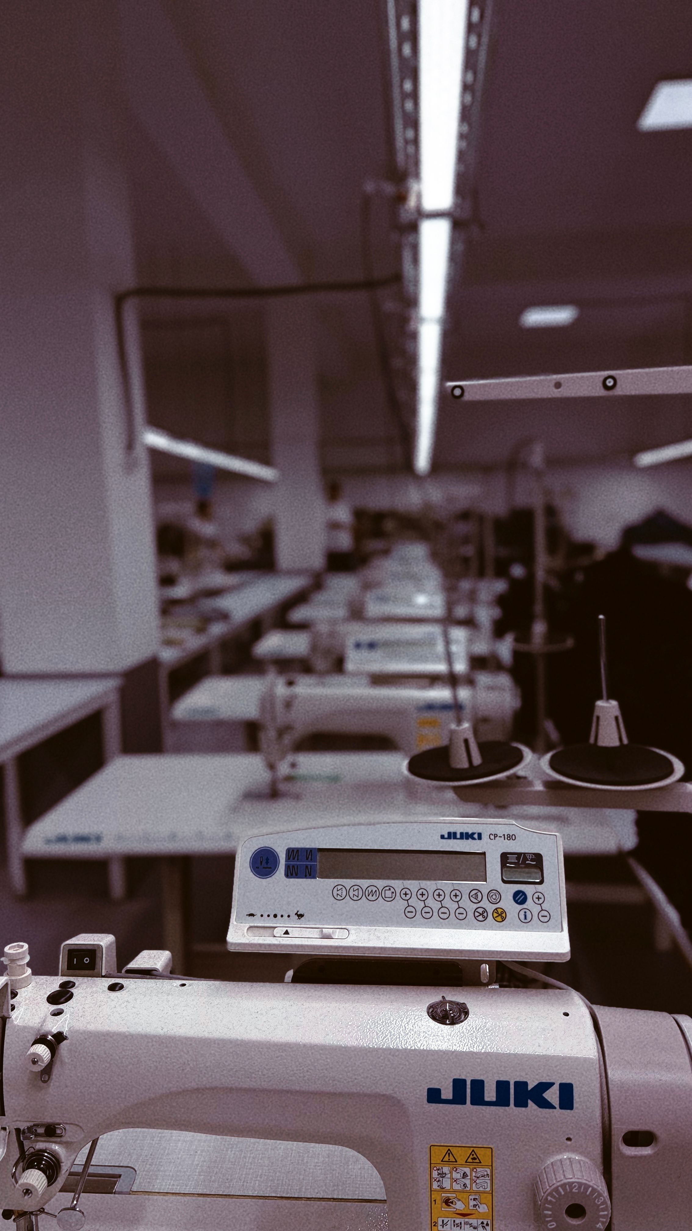 row of sewing machines on a production floor
