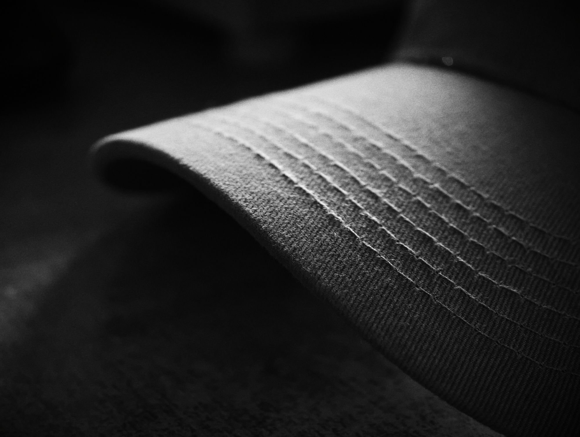close-up of a cap peak with rows of stitching